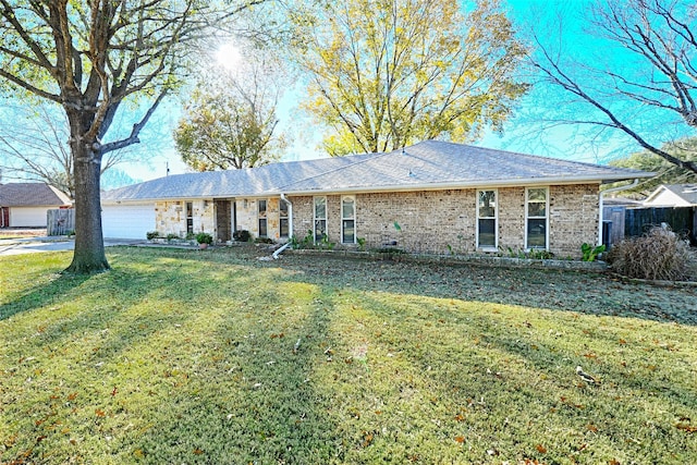 ranch-style home featuring a garage and a front yard