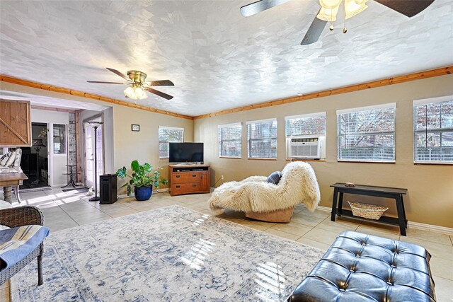 living room with ceiling fan, brick wall, crown molding, a textured ceiling, and light tile patterned floors