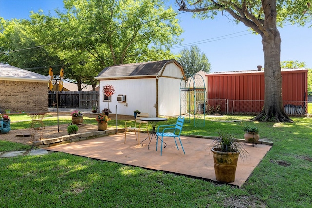 view of patio / terrace with a fenced backyard, an outdoor structure, and a storage shed