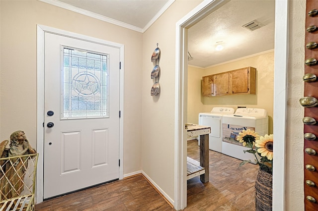 entryway with visible vents, baseboards, independent washer and dryer, ornamental molding, and dark wood-style floors