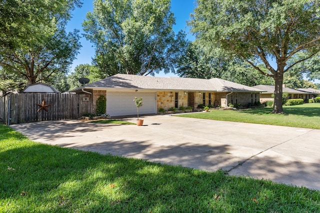 ranch-style house with an attached garage, a gate, fence, concrete driveway, and a front lawn