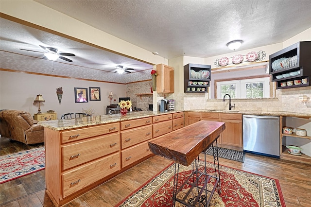 kitchen featuring a sink, a peninsula, a textured ceiling, open shelves, and dishwasher