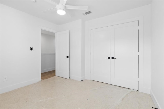 unfurnished bedroom with a closet, ceiling fan, and light colored carpet