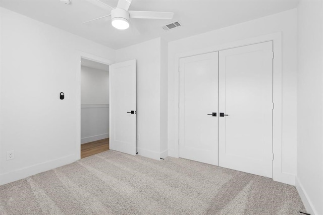 unfurnished bedroom with carpet flooring, ceiling fan, and a closet