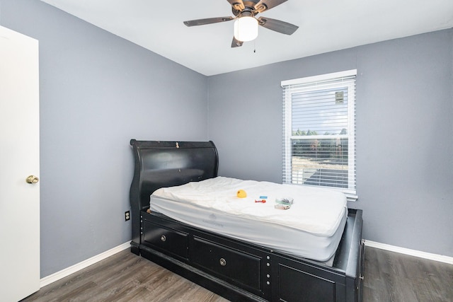 bedroom with ceiling fan and dark hardwood / wood-style flooring