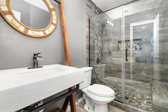 bathroom featuring wood-type flooring, toilet, and an enclosed shower