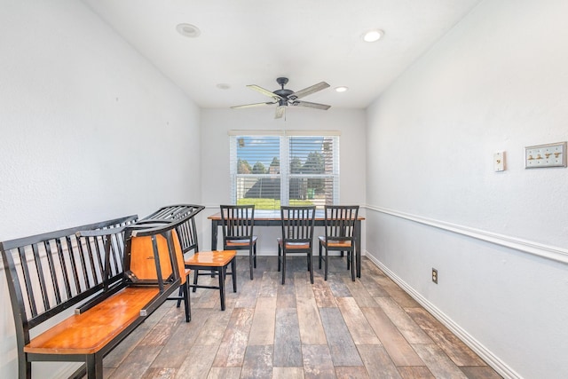 sitting room with ceiling fan and wood-type flooring