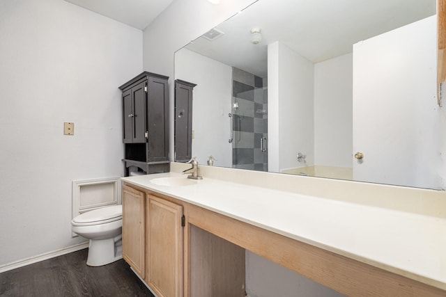 bathroom with wood-type flooring, vanity, toilet, and an enclosed shower