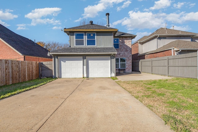 rear view of property featuring a garage and a lawn