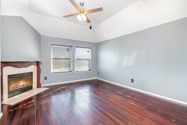 unfurnished living room with a premium fireplace, ceiling fan, dark hardwood / wood-style floors, and lofted ceiling