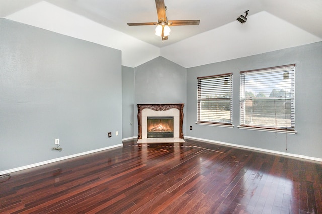 unfurnished living room with a premium fireplace, hardwood / wood-style floors, ceiling fan, and vaulted ceiling