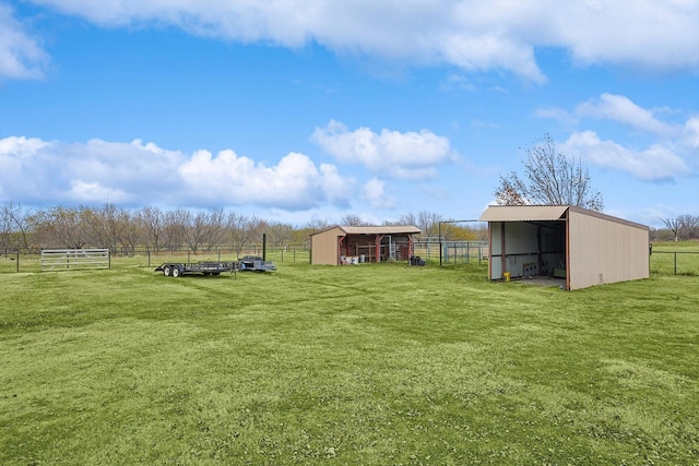 view of yard featuring a rural view and an outdoor structure