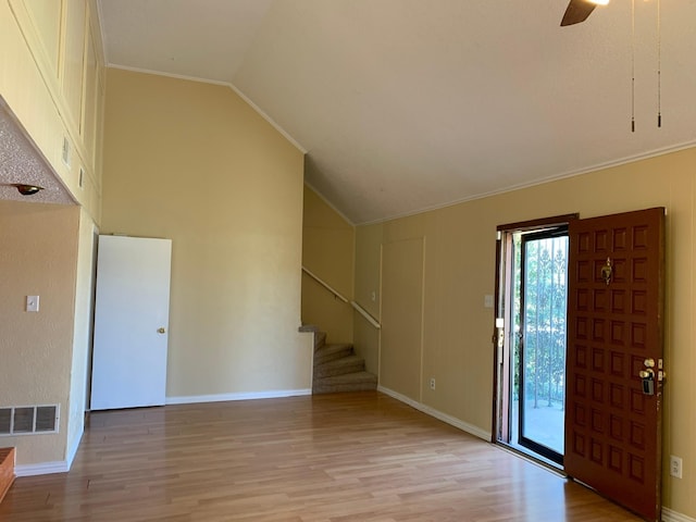 entrance foyer with crown molding, vaulted ceiling, light hardwood / wood-style floors, and ceiling fan