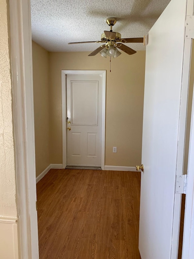 interior space with hardwood / wood-style floors, a textured ceiling, and ceiling fan