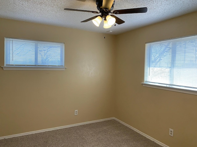 carpeted empty room featuring ceiling fan and a textured ceiling