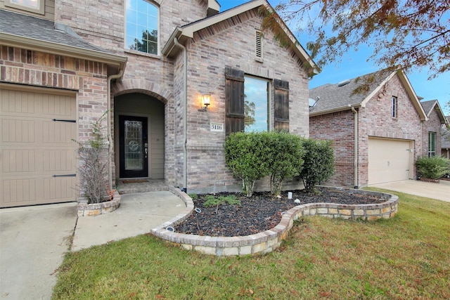 view of exterior entry with a yard