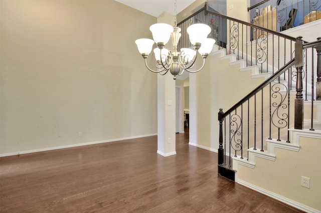 entrance foyer with dark hardwood / wood-style flooring and a notable chandelier