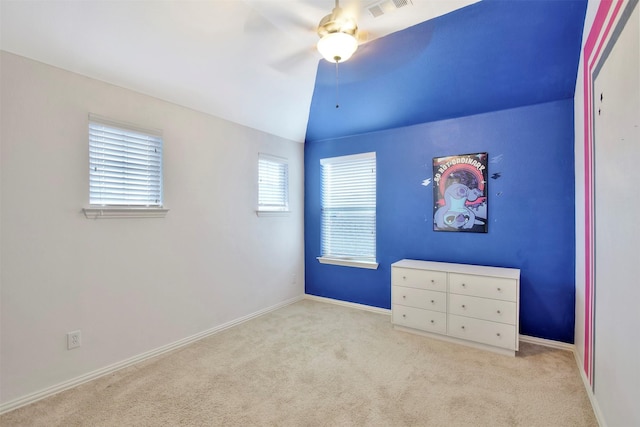 unfurnished bedroom featuring ceiling fan, lofted ceiling, and light carpet