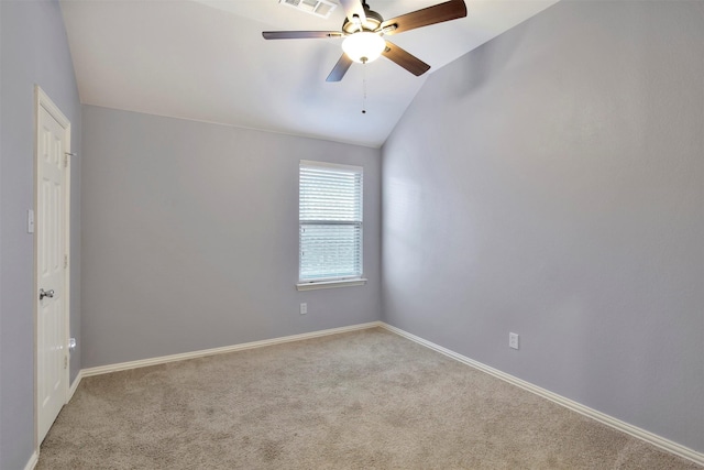 carpeted empty room with ceiling fan and vaulted ceiling