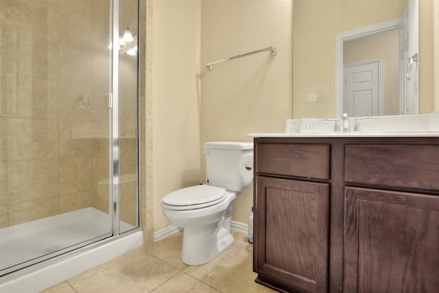 bathroom with tile patterned flooring, vanity, toilet, and a shower with door