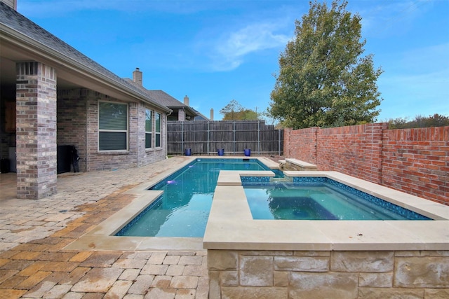 view of swimming pool featuring an in ground hot tub