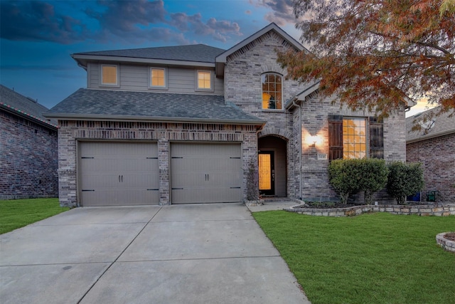 view of front of house featuring a garage and a lawn