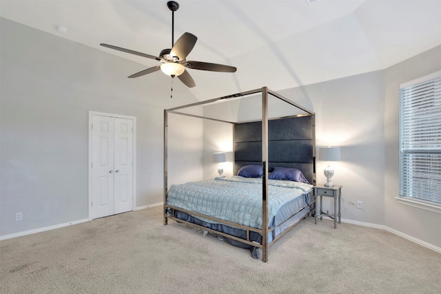 bedroom featuring light carpet, vaulted ceiling, and ceiling fan