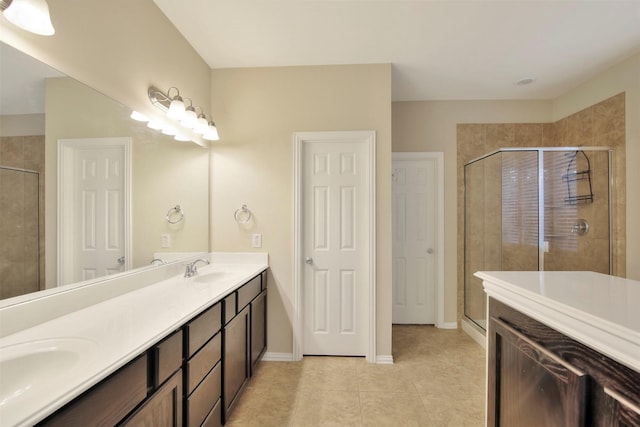 bathroom with tile patterned floors, a shower with door, and vanity