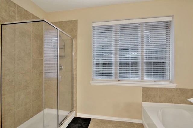 bathroom featuring tile patterned flooring and plus walk in shower