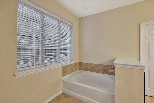 bathroom with tile patterned floors and a bathing tub