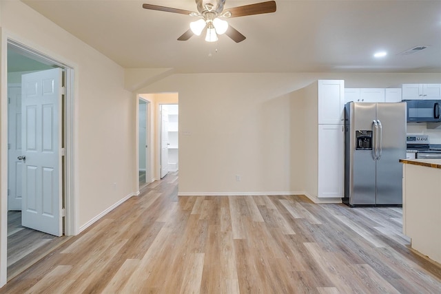 interior space with white cabinetry, light hardwood / wood-style flooring, ceiling fan, and appliances with stainless steel finishes