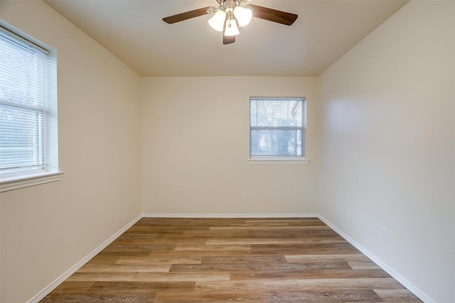 empty room featuring ceiling fan and light hardwood / wood-style flooring