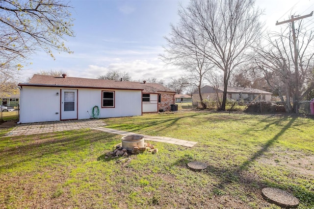 exterior space featuring a yard and a fire pit