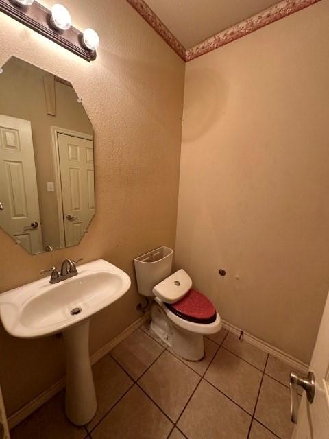 bathroom with tile patterned floors and toilet