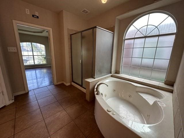 bathroom featuring tile patterned flooring and plus walk in shower