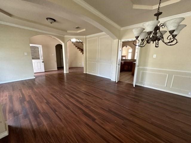 unfurnished dining area featuring crown molding, a chandelier, and dark hardwood / wood-style floors