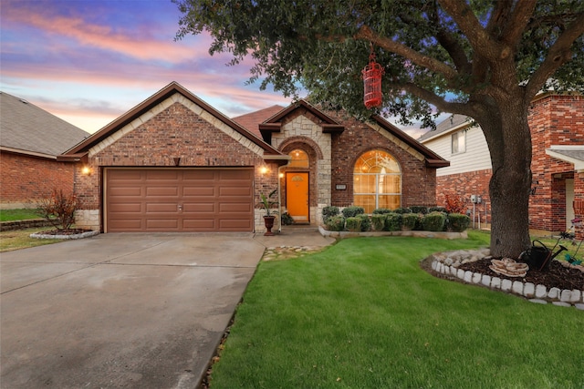 view of front of home featuring a lawn and a garage