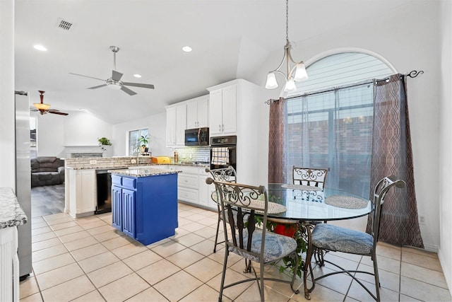 kitchen featuring white cabinetry, decorative backsplash, and vaulted ceiling