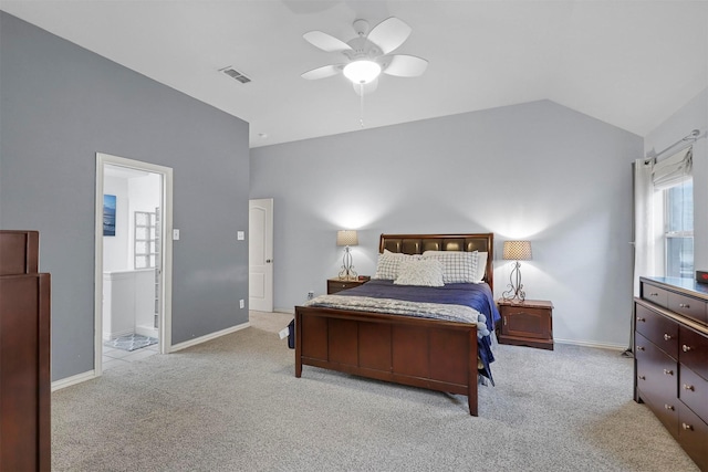 bedroom featuring ensuite bathroom, vaulted ceiling, ceiling fan, and light colored carpet