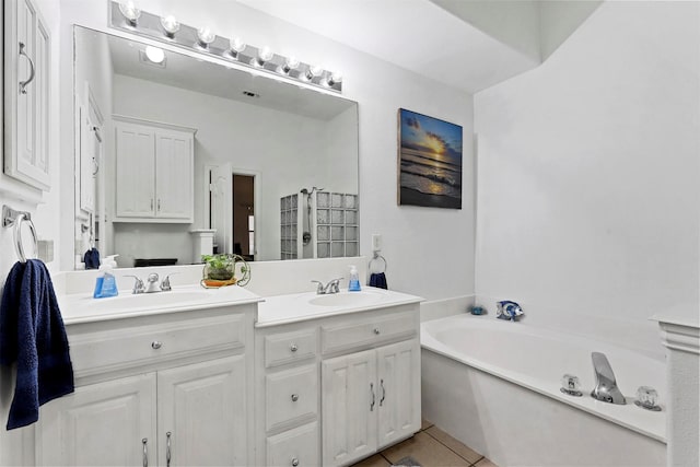 bathroom with tile patterned flooring, vanity, and a bathtub