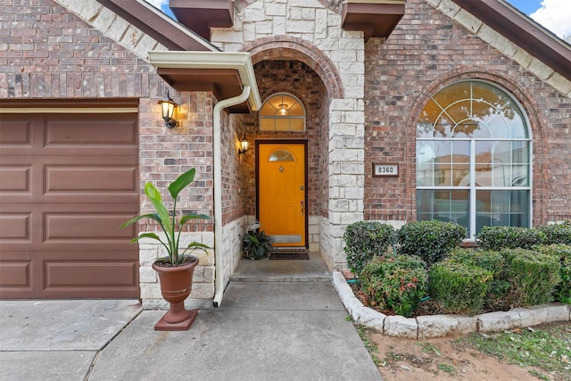 doorway to property with a garage