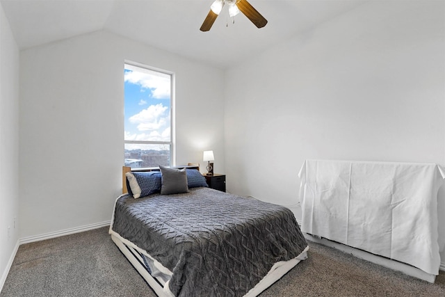 carpeted bedroom with ceiling fan and vaulted ceiling