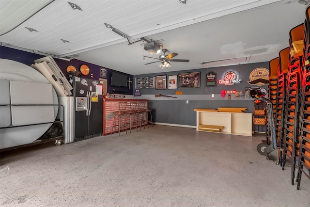 garage with stainless steel fridge with ice dispenser, ceiling fan, and a garage door opener