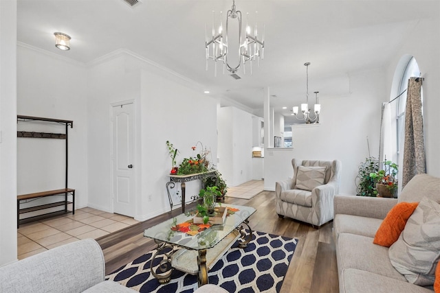 living room featuring crown molding and light hardwood / wood-style flooring