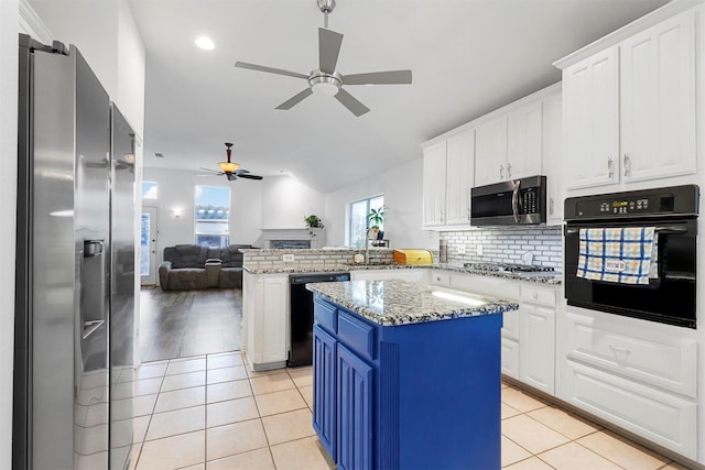 kitchen with white cabinetry, light tile patterned floors, kitchen peninsula, a kitchen island, and black appliances