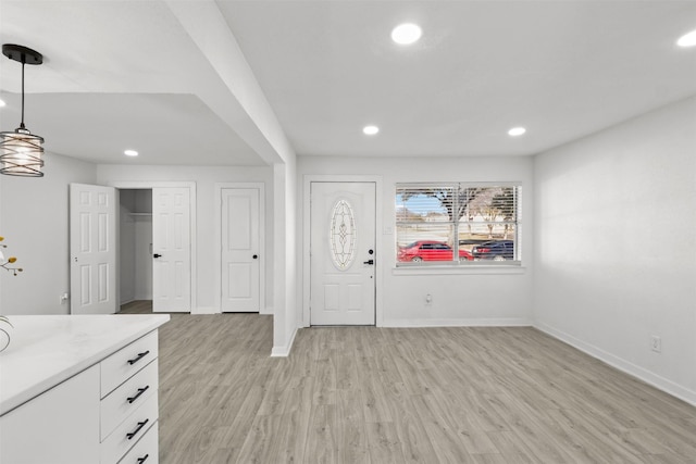 foyer entrance with light hardwood / wood-style flooring