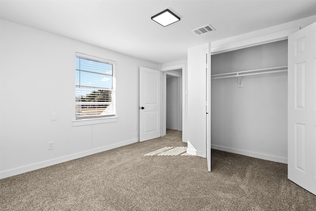 unfurnished bedroom with carpet floors and a closet