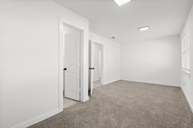 spare room with light colored carpet