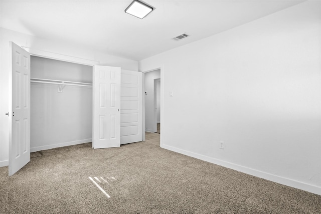 unfurnished bedroom with carpet and a closet