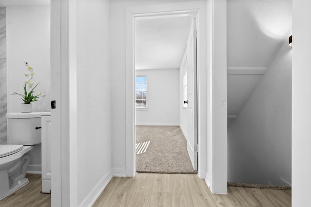 corridor with light hardwood / wood-style flooring